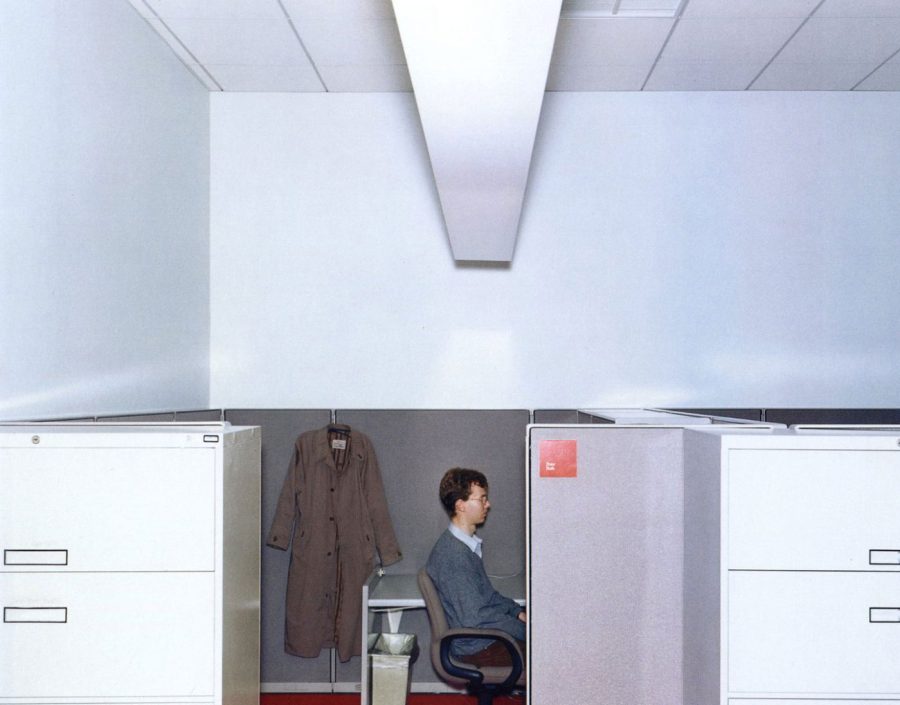 In a Lars Tunbjörk photograph, a man sits in an office.