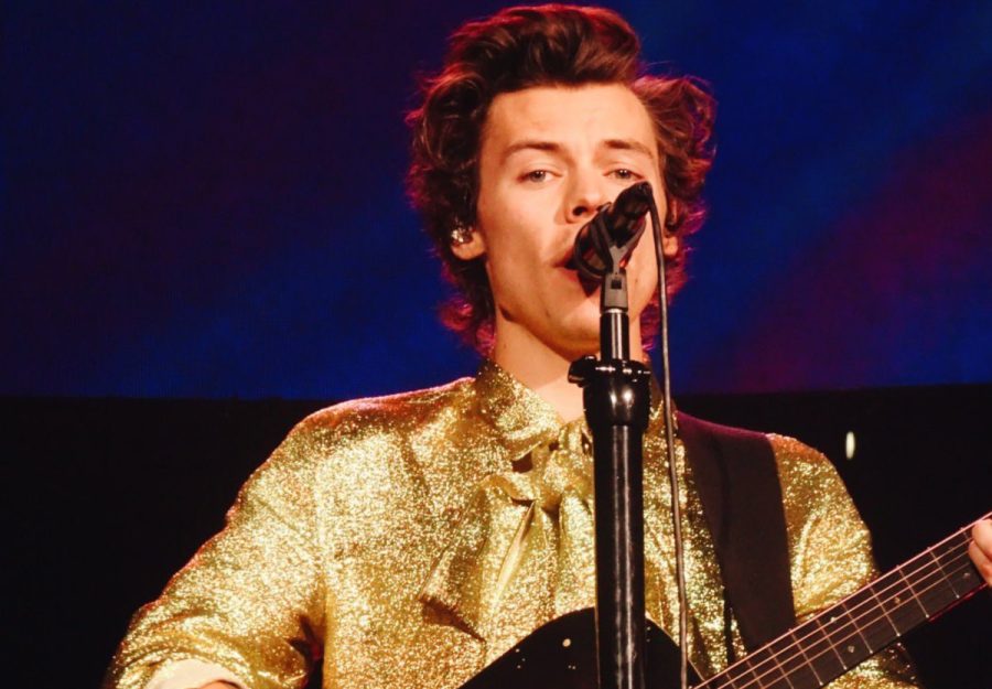 Harry Styles, who recently won Album of the Year at the Grammys, performs at a concert. 
