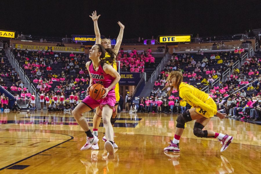 Caitlin+Clark+%28in+pink%29+of+Iowa+competes+in+a+womens+basketball+game.