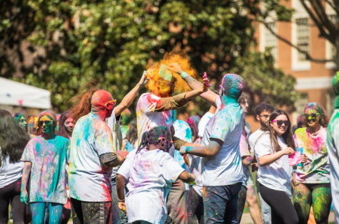 Students cover each other in colorful powders in observance of Holi.
