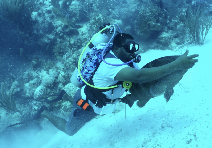 A student scuba dives in Belize.