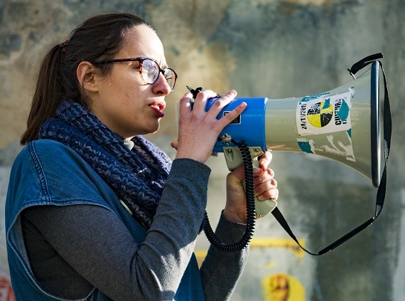 A protestor speaks into a megaphone.