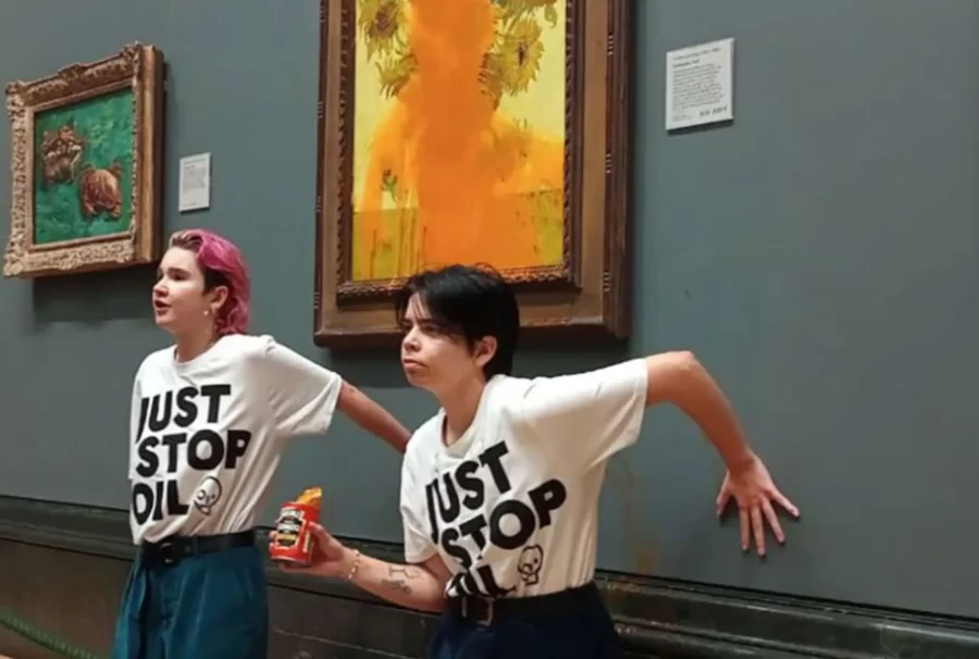 Activists pose after dousing Van Goghs Sunflowers with tomato soup.
