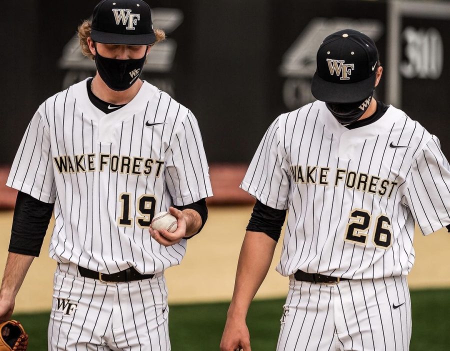 Two Wake Forest baseball players don masks.