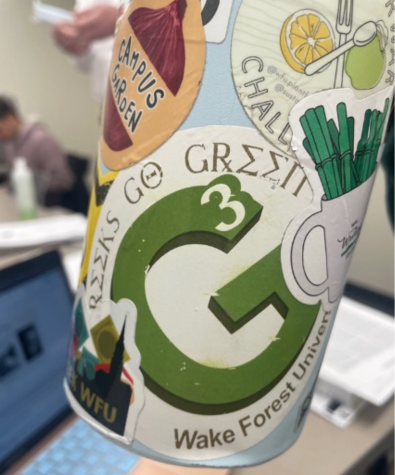 A Greeks Go Green sticker is displayed on a water bottle.