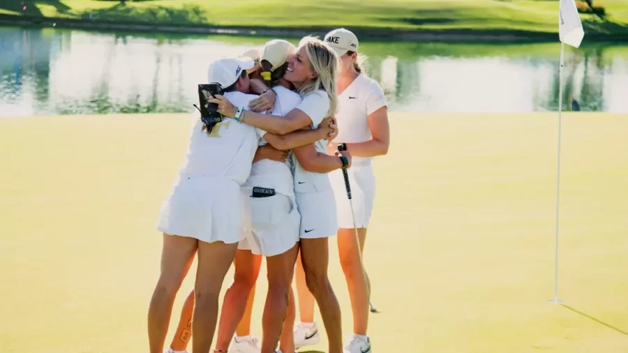 The womens golf team celebrates after winning a national championship.