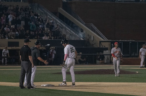 3rd basemen Brock Wilken celebrates after his single brings Lucas Costello across home plate for the first score of the game.