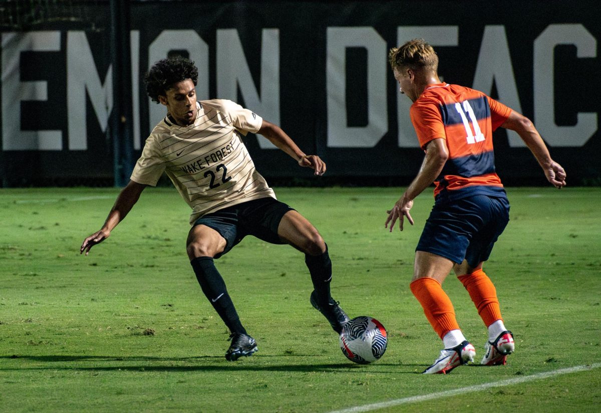 Sidney Paris (22) defends a Syracuse player during Saturday’s match. Paris scored Wake Forest’s only goal on a penalty kick in the 74th minute.