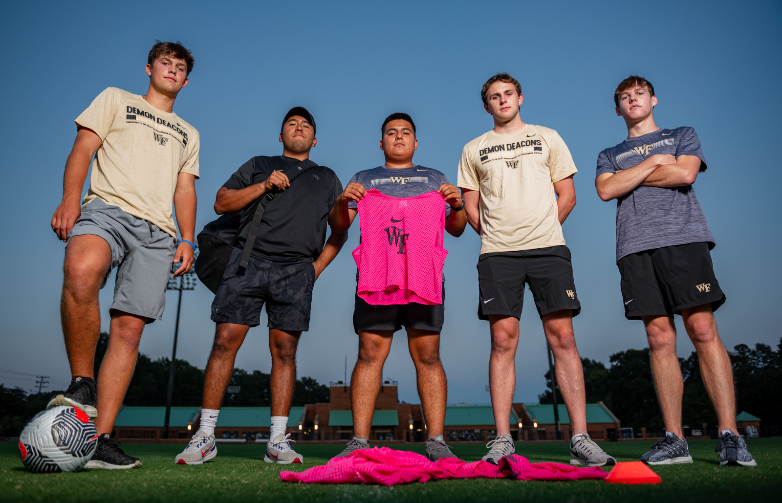 From left to right: Tyler Thompson, Nico Machado, Manny Guevara, Tyler Fausnaught, Ethan Humphrey, pose on Spry Practice Field after working and wrapping an evening practice. With three seasons of experience, Guevara leads the group as head manager.