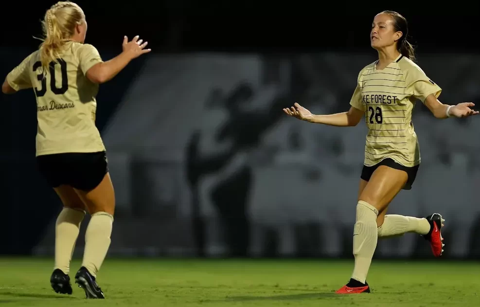 Midfielders Anna Swanson (left) and Carly Wilson (right) celebrate on the field (Courtesy of WFU Athletics).