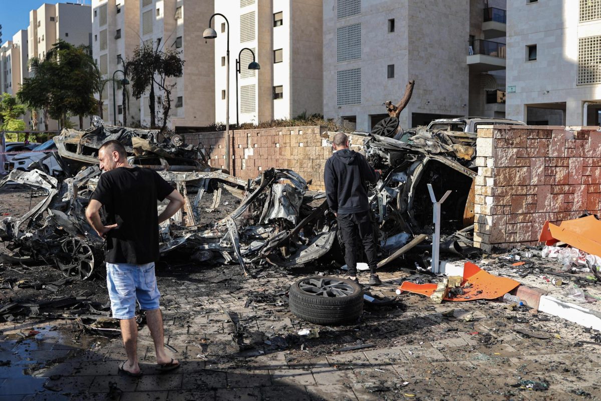 People in Israel survey damage from a rocket attack on Oct. 7 (Courtesy of CNBC).