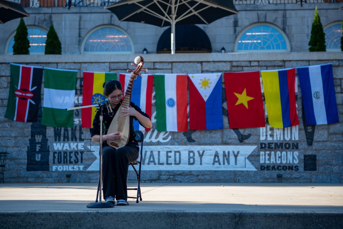 Sophomore Leilei “Ray” Pu performs a song on the Chinese pipa before a crowd of spectators. 