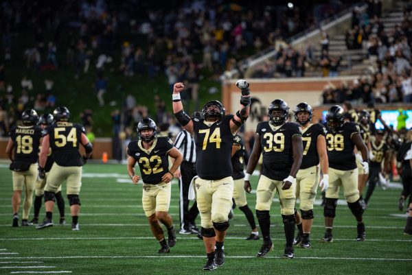 Luke Petitbon and the Wake Forest offense celebrate on the field.