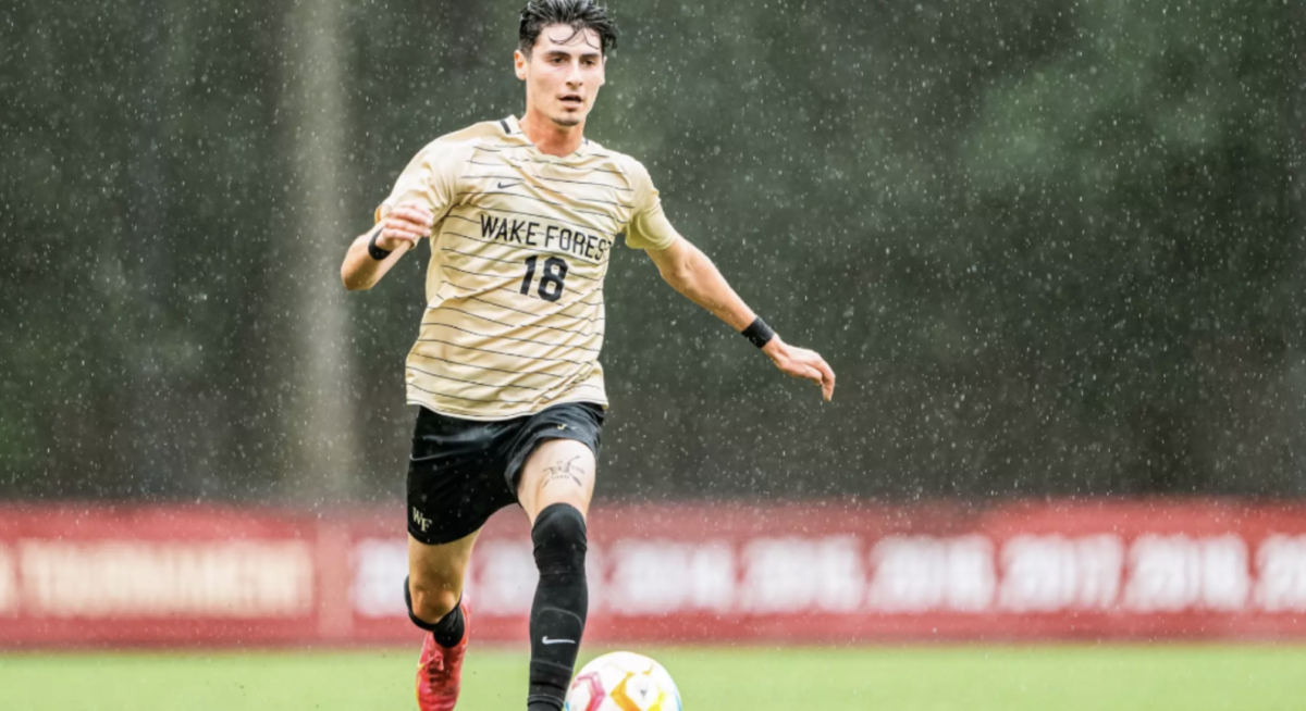 Junior midfielder Cooper Flax dribbles the ball downfield against Boston College (Courtesy of Wake Forest Athletics).