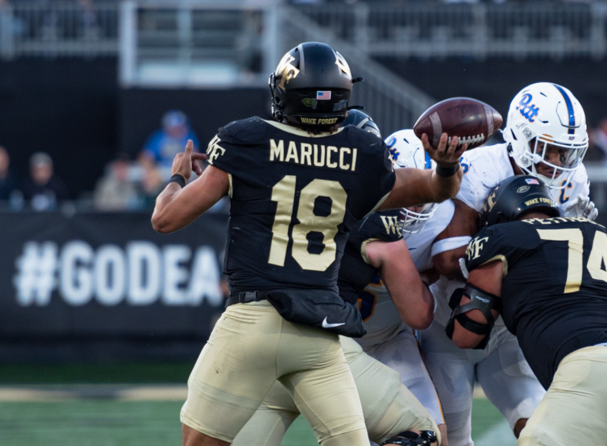 Third-string quarterback, former running back and safety, Santino Marucci throws a pass in his first career college start. Marucci finished 12-21 for 151 yards, 1 TD and 2 INT. 
