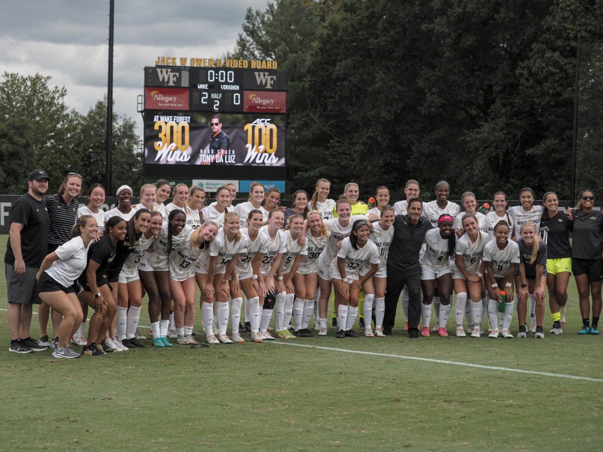 Wake Forest women’s soccer gathers for a team picture to celebrate Head Coach Tony da Luz’s (front row in black) 300th career win and 100th career ACC victory. (Sept. 24, 2023)