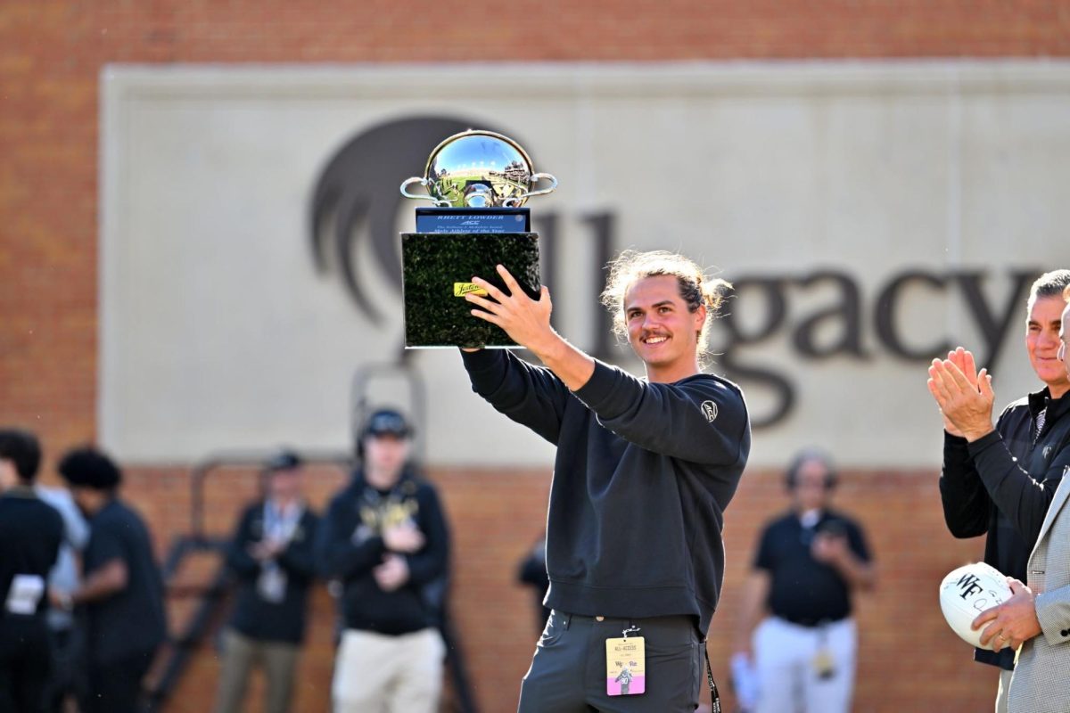 Wake Forest pitcher and MLB first-round draft pick Rhett Lowder accepts his 2022-23 ACC Male Athlete of the Year trophy during a break in the Wake Forest-Florida State football game. (Oct. 28, 2023)
