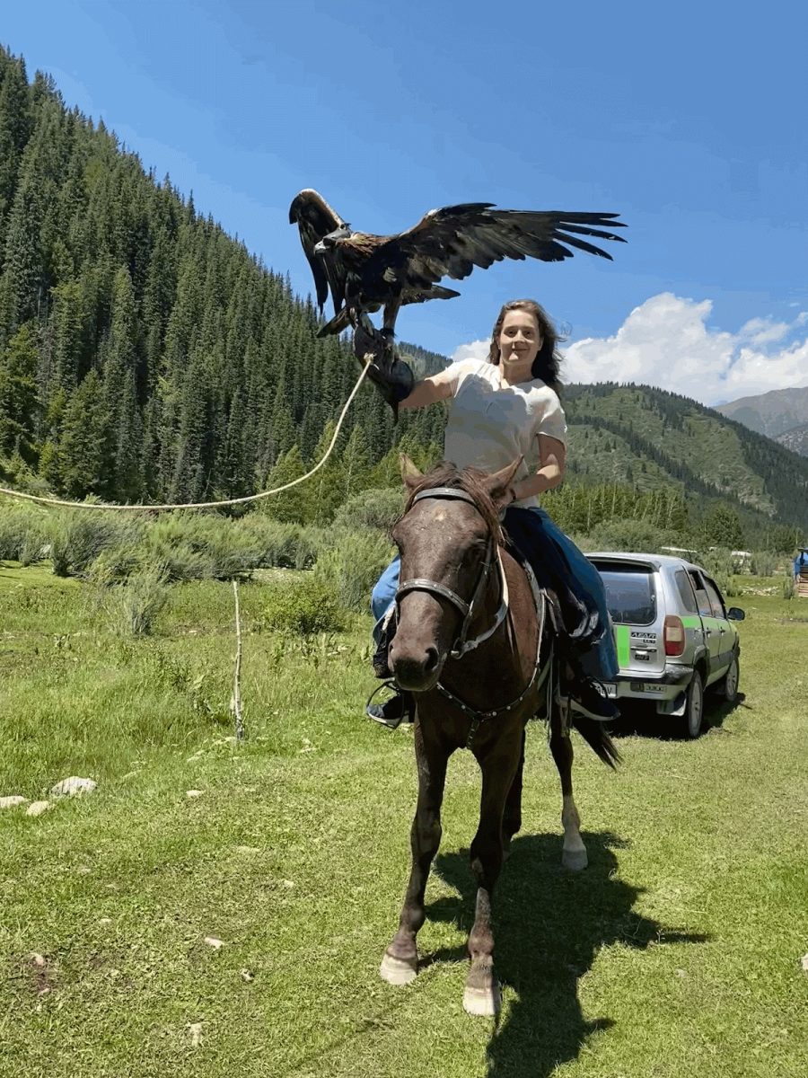 Isabella+Romine+poses+on+a+horse+during+her+2023+summer+study+abroad+experience+in+Kyrgyztan+as+part+of+the+Critical+Language+Scholarship.