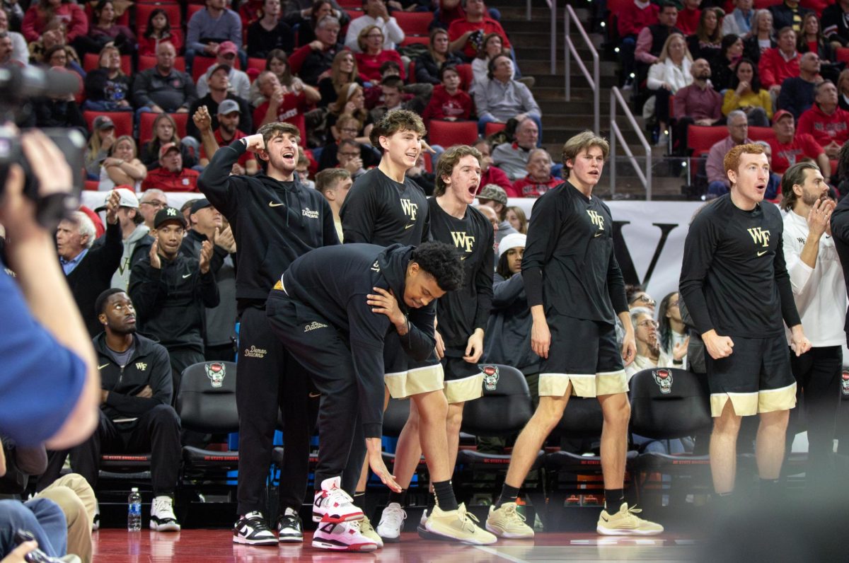 The Wake Forest bench celebrates shots made by their teammates in the first half. 