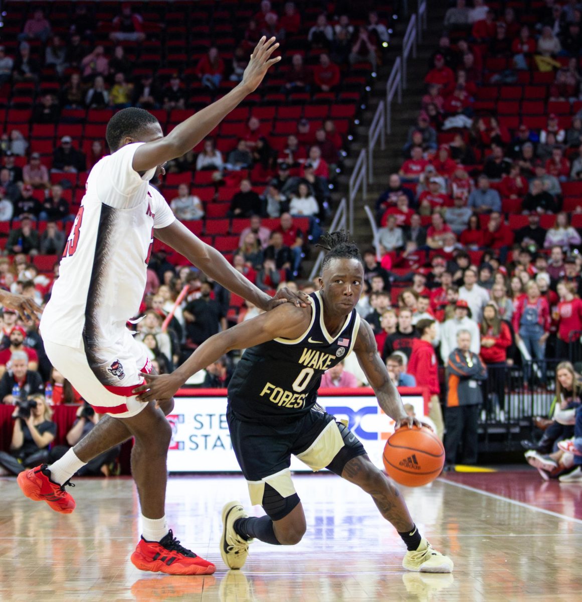 Kevin “Boopie” Miller (0) dribbles past NC State.