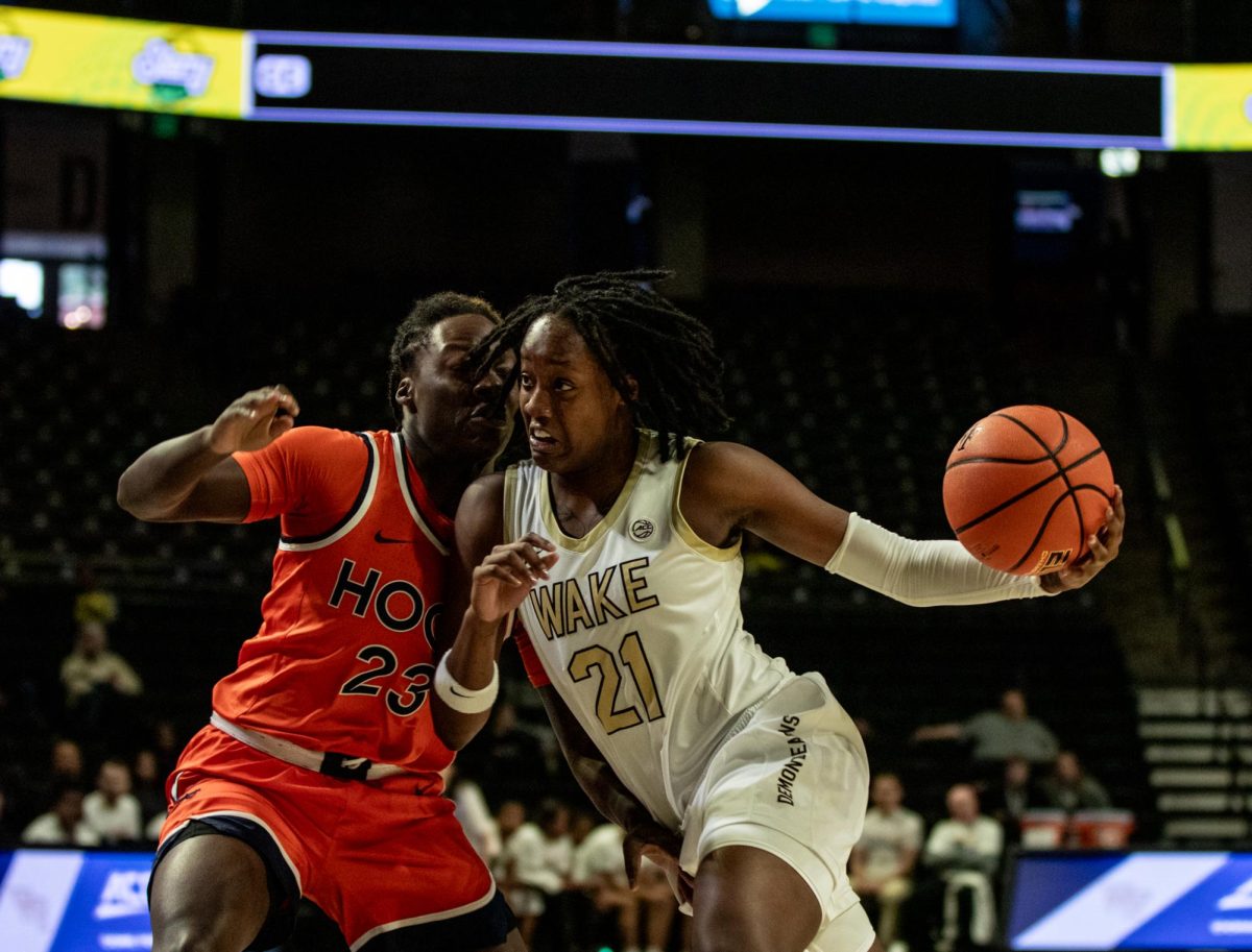 Elise Williams (21) takes on the UVA defender in the second half. Williams led the team in points this afternoon, finishing with 26 points.