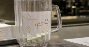 The tip jar at Campus Gas rests on the bar counter. Campus Gas, which is frequented by Wake Forest students and is owned and operated by Wake Forest alumni, is a business where its employees rely on tips to supplement their wages due to North Carolina law.