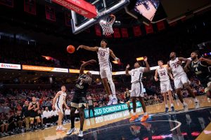 Virginia’s Ryan Dunn (13) swats away an attempted basket by Kevin “Boopie” Miller (0). Dunn finished the afternoon with a career-high seven blocks.