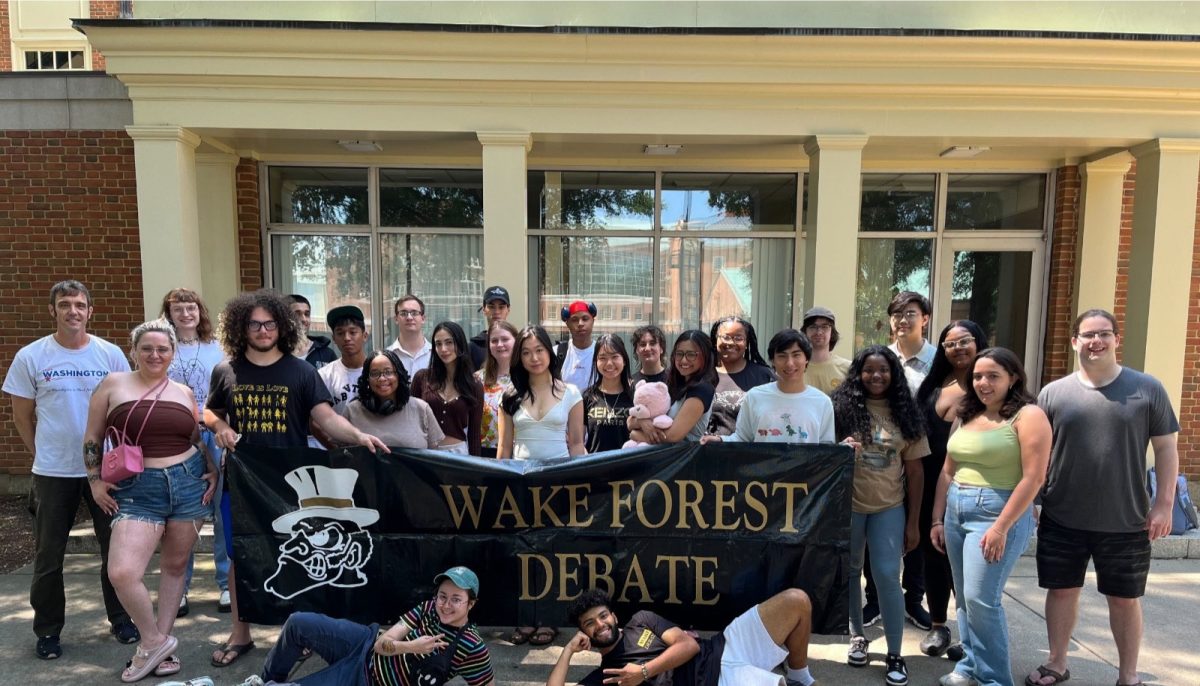 Members of the award-winning Wake Forest Debate team pose alongside the pro- gram’s poster. The Wake Debate team was the focus of the documentary “Breathing Fire.”
