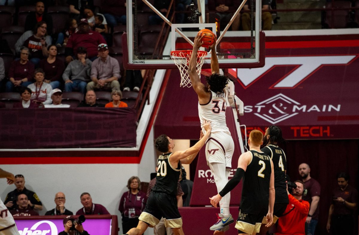 Virginia Tech’s Mylyljael Poteat (34) slams over Wake Forest’s Parker Friedrichsen (20). Poteat had six points in the matchup.