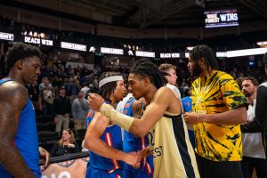 Hunter Sallis and Efton Reid shake hands with the Florida Gators after an 81-72 win last November. The Gators received a bid as the 7-seed in the NCAA Tournament.