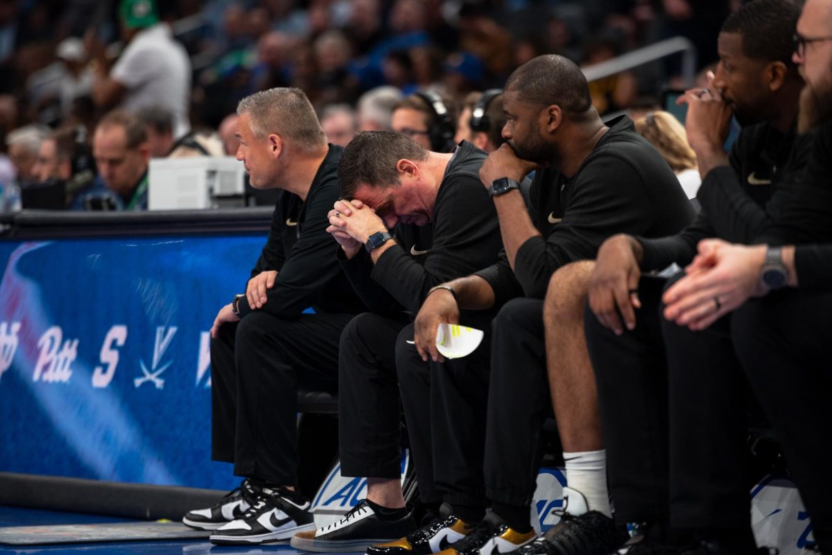 Wake Forest assistant coaches look on in frustration as time winds down in the contest.