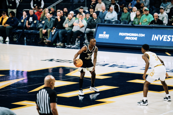 Boopie Miller (0) dribbles near half-court while being guarded by Notre Dame’s Markus Burton (3). Burton had 31 points in the matchup. (Courtesy of Wake Forest Athletics)