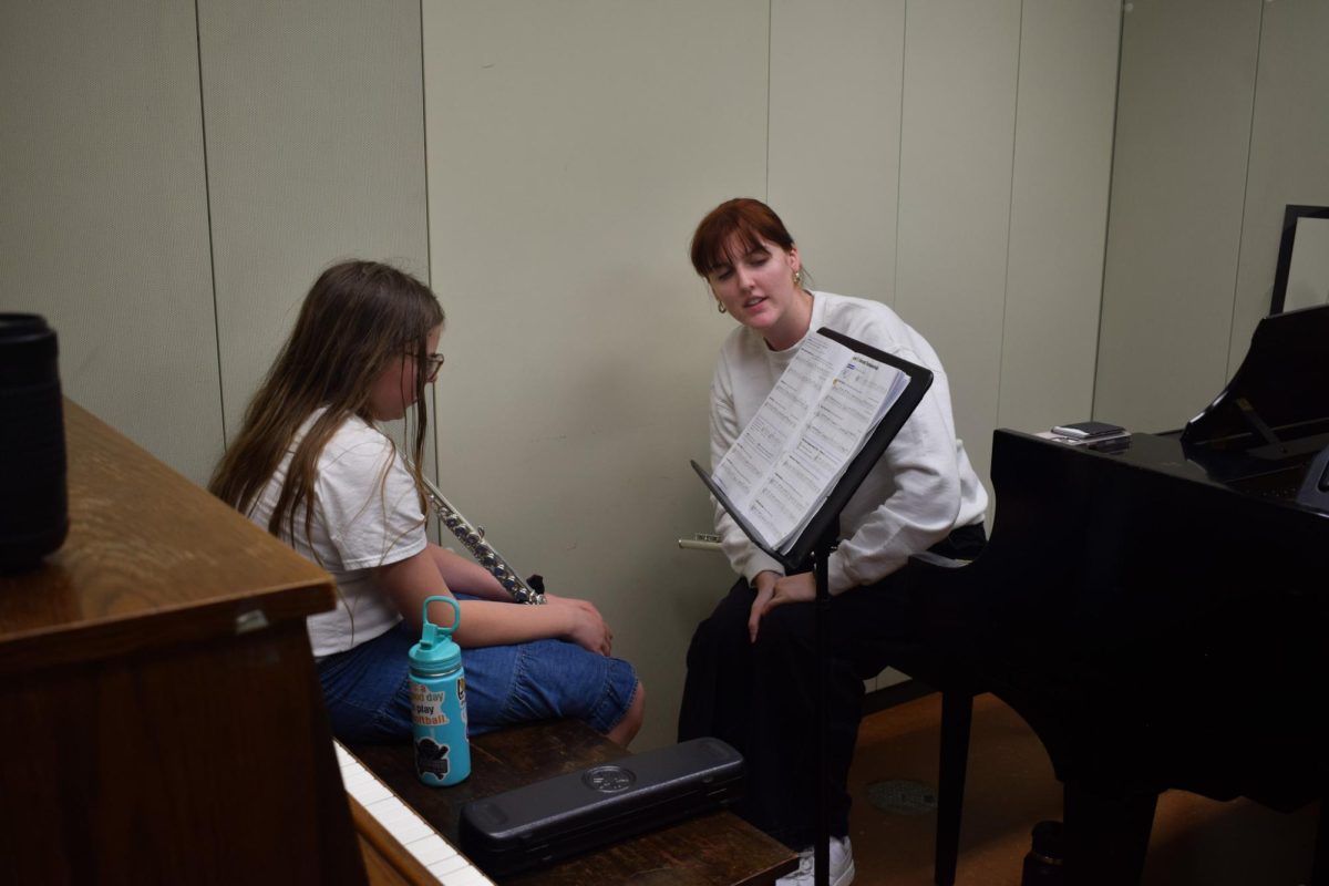 Cora Roach (left) attends a Musical Empowerment flute lesson taught by Alyssa Zaepfel (right).