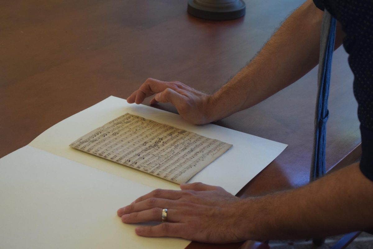 Christopher Ogburn of the Moravian Music Foundation looks at one of Johannes Herbst's handwritten copies.