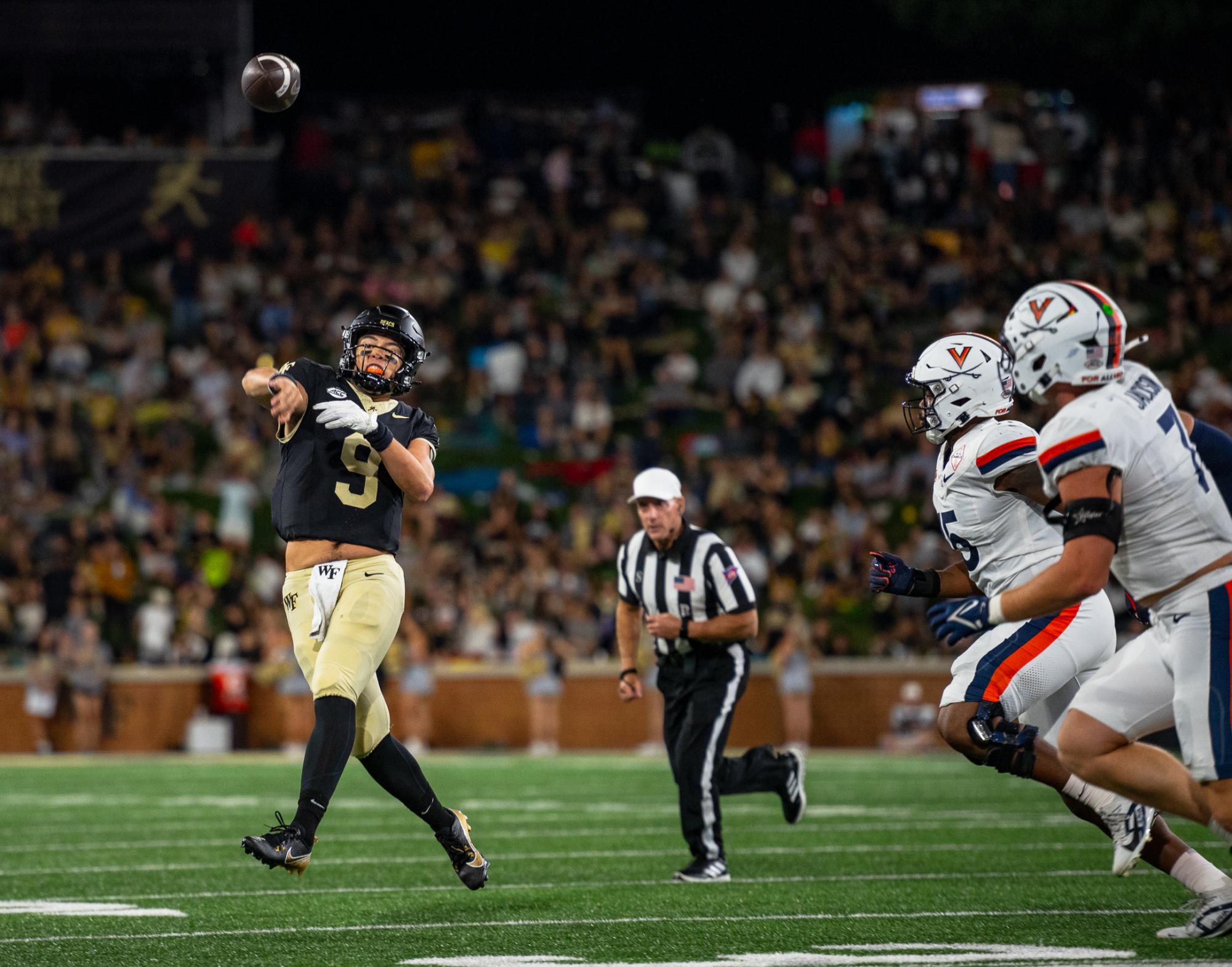 Wake Forest quarterback Hank Bachmeier (9) completes a throw against the Virginia Cavaliers defense. Bachmeier had 403 yards and one touchdown on the night. 