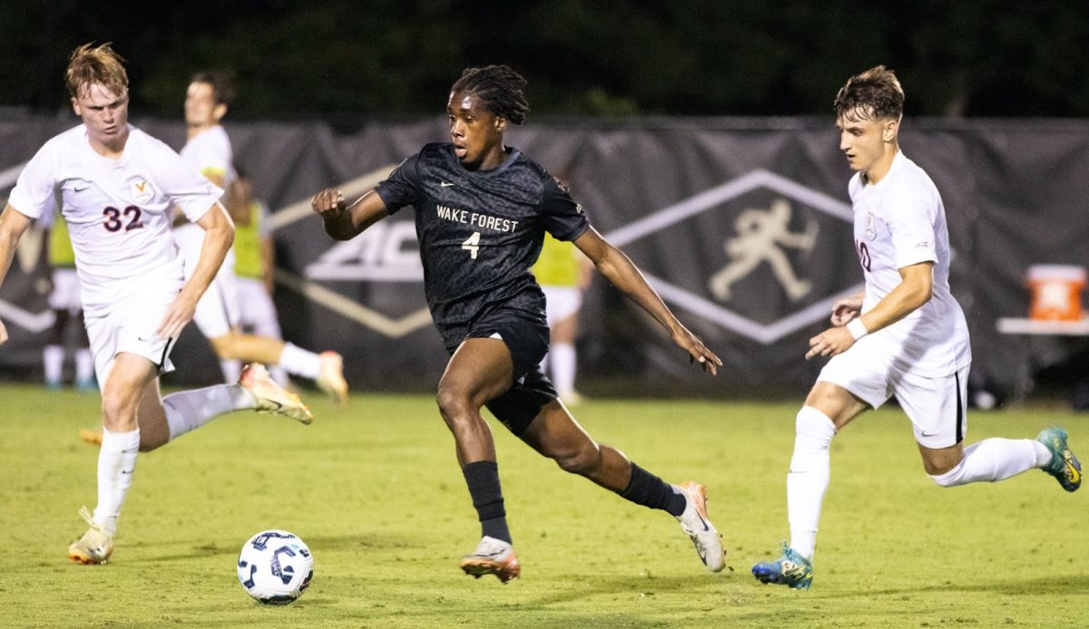 Wake Forest freshman Amoni Thomas (4) drives through Virginia defenders during Friday night’s ACC opener for the Demon Deacons.