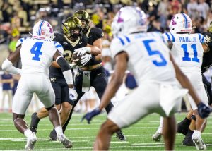 Ole Miss defenders prepare for a rush by Wake Forest running back Tate Carney (30) after a handoff from quarterback Hank Bachmeier (9).