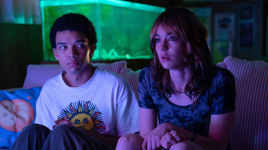 Owen (Justice Smith) and Maddy (Brigette Lundy-Paine) watch The Pink Opaque, a TV show within the world of "I Saw the TV Glow." (Courtesy of IMDb)
