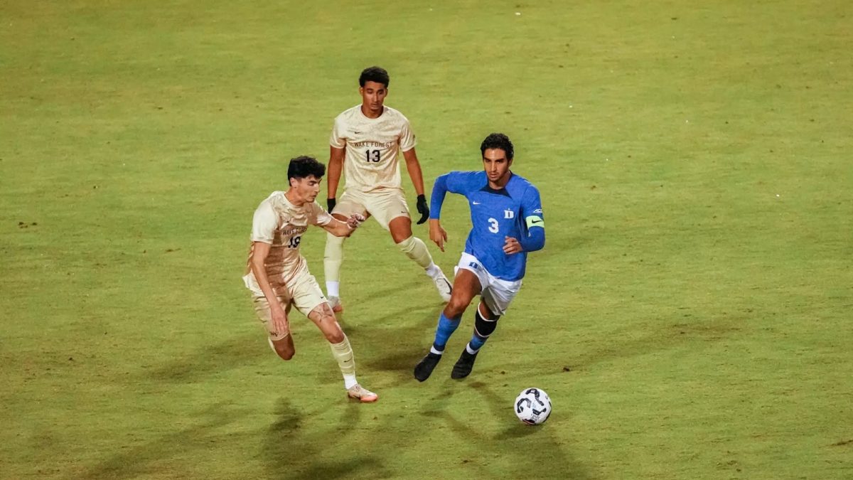 Midfielders Cooper Flax (18) and Jeffrey White (13) take on Duke’s Kamran Acito (3) during last week’s draw. (Courtesy of Wake Forest Athletics)