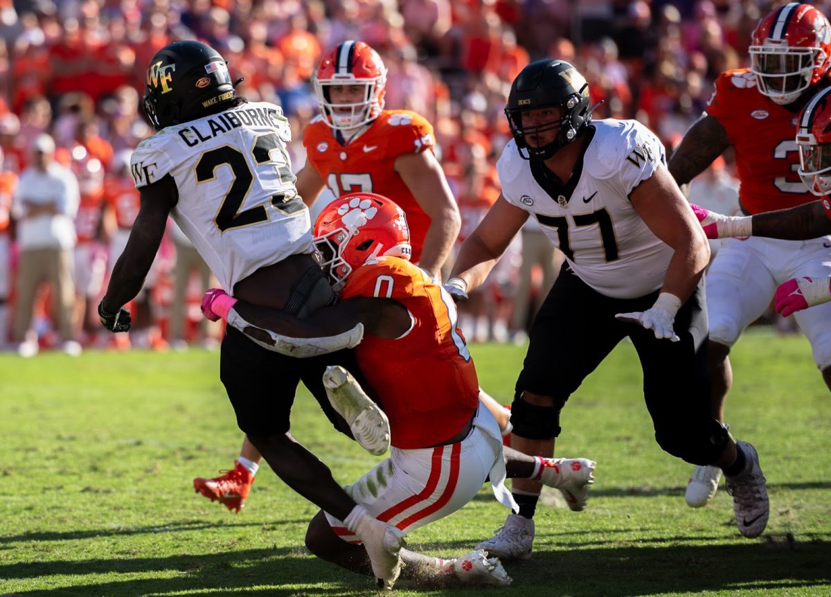 Demond Claiborne (23) is tackled by Clemson linebacker Barrett Carter (0) last season in a 17-12 loss at Clemson’s “Death Valley.” Claiborne has seven total touchdowns on the year so far.