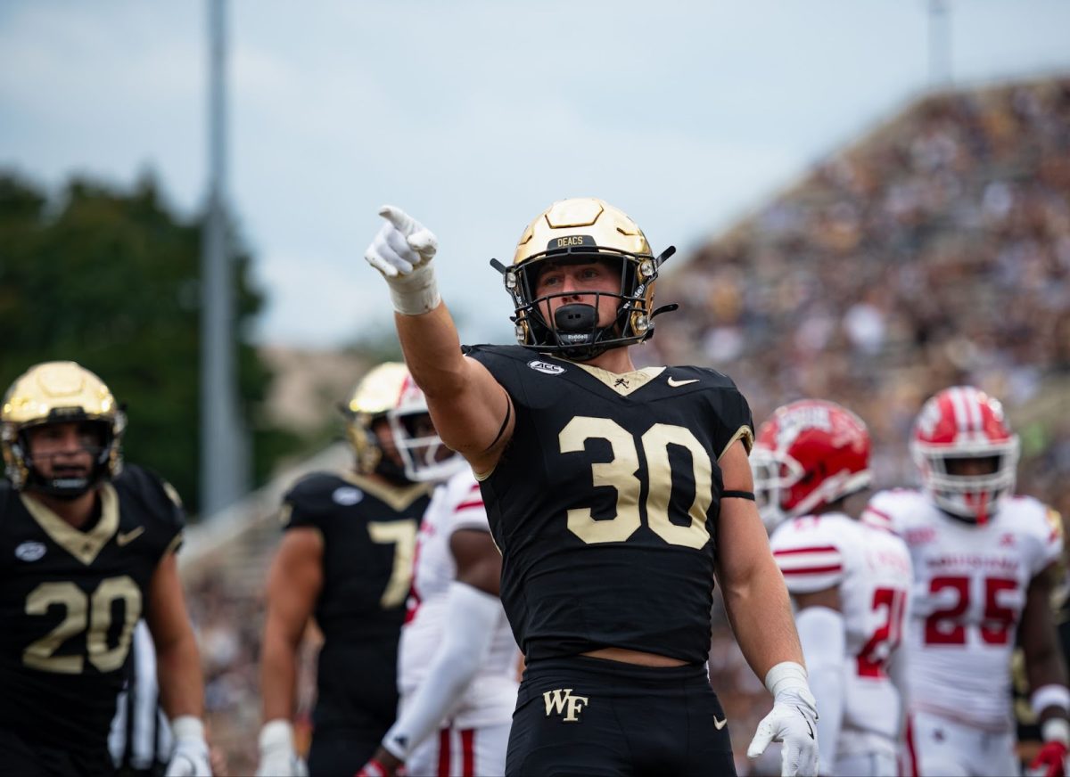 Running back Tate Carney (30) claims a Wake Forest first down during his three-touchdown outing for the Demon Deacons on Saturday.