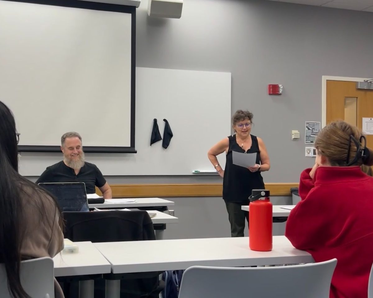 Margaret Bender, the chair of the Anthropology Department and a Linguistics faculty member,
introduces Jeffrey Bourns and his talk “The Deverbal Origins of Cherokee Adjectives.”