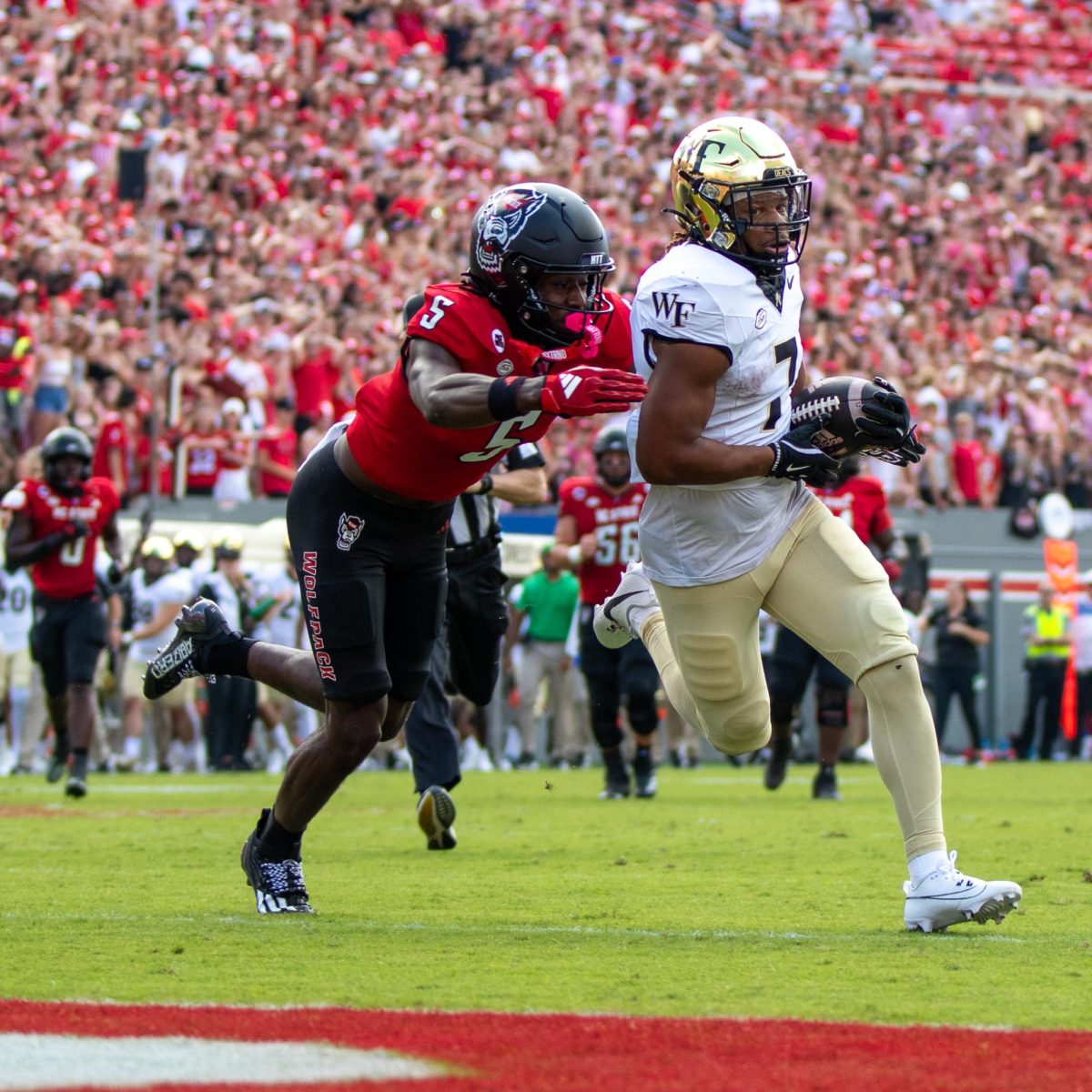 Wake Forest linemen prevent oncoming NC State defenders from disrupting a Wake Forest kick to the uprights.