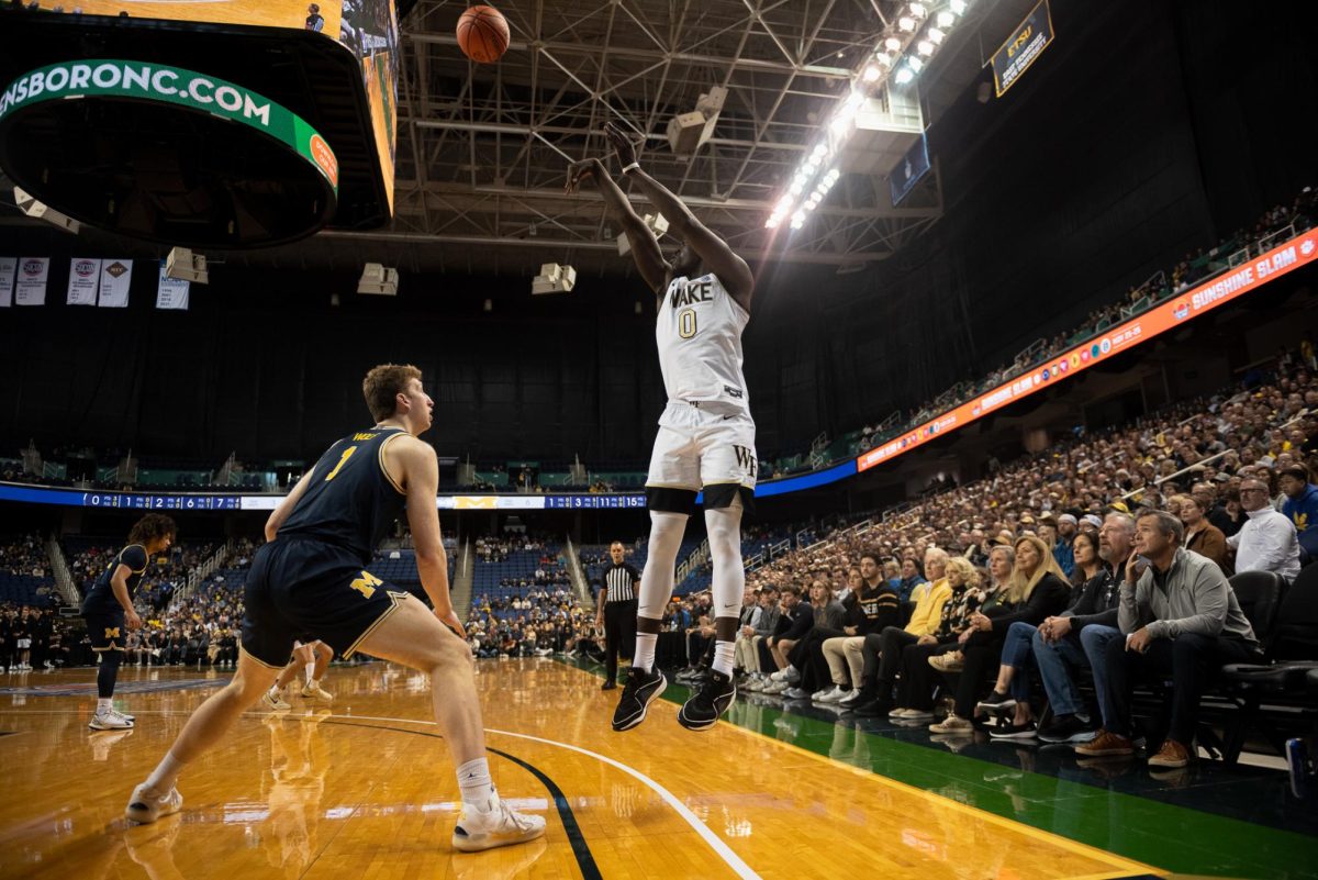 Transfer forward Omaha Biliew (0) knocks down one of Wake Forest's six three pointers late in the first half.