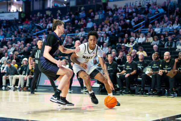 Freshman Juke Harris (2) drives to the basket against a Western Carolina defender. With an injury to center Efton Reid III, Head Coach Steve Forbes adjusted lineups and used Harris in a new role at power forward.