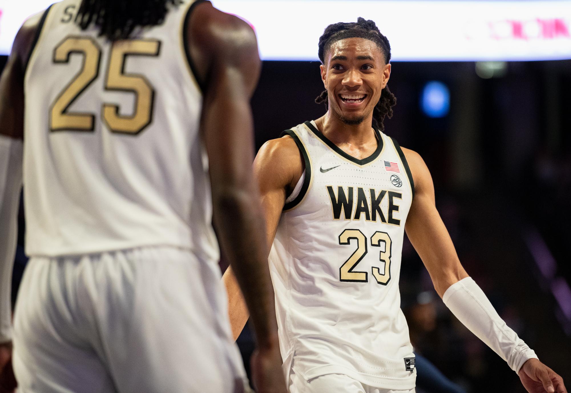 Hunter Sallis (23) jokes with transfer Tre'Von Spillers (25) at the free throw line.