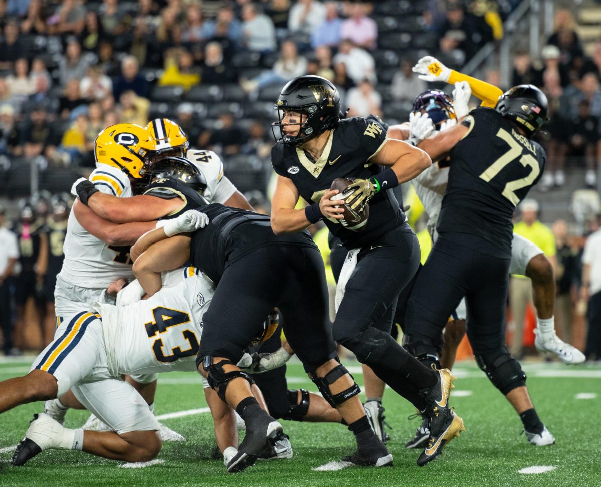 Wake Forest quarterback Hank Bachmeier (9) scrambles to escape a collapsing pocket. Bachmeier faced serious pressure as he was sacked seven times in Friday night’s loss to Cal.