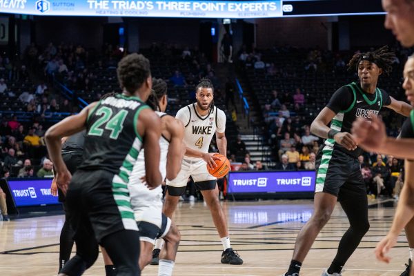 Wake Forest center Efton Reid (4) looks for a teammate during Wednesday night’s win versus USC Upstate. Reid had 14 points and a game-high 8 rebounds on the night.