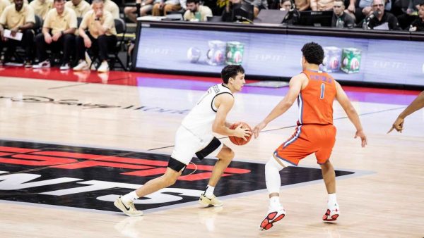 Parker Friedrichsen (7) looks to drive on Florida’s Walter Clayton Jr. (1). Clayton Jr. led the ESPN Events Invitational’s semifinal game in scoring with 21 points. (Courtesy of Wake Forest Athletics)