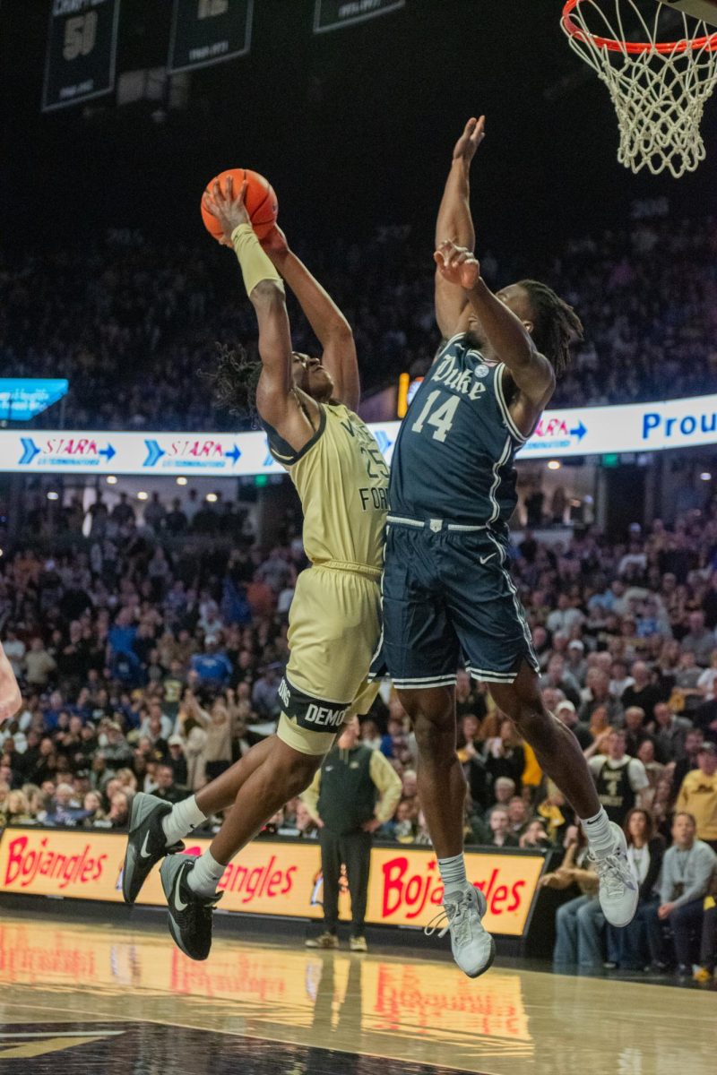 Forward TreVon Spillers (25) rises to the rim against Duke Guard Sion James (14). Spillers has given the Deacs a huge energy boost since transferring from Appalachian State.